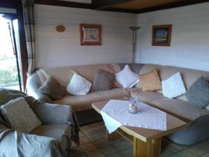 a living room with a couch and a coffee table at Holiday home on Lake Henne with terrace in Meschede