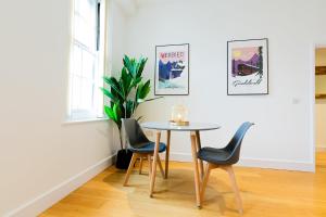 a table and chairs in a room with a window at Modern and Spacious 1 Bed Apartment City Centre in Norwich