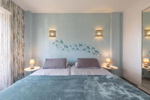 a bedroom with a large bed and two lamps at Beach apartment La Cala in La Cala de Mijas +36 photos
