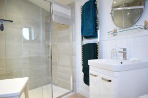 a bathroom with a shower and a sink and a mirror at Isle of Skye Rotunda in Ollach +14 photos