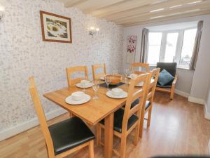 comedor con mesa de madera y sillas en Bryn Bethel, en Penrhyndeudreath