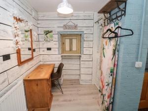 a small room with a wooden table and a chair at The Studio in Tenby