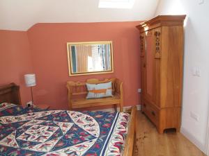 a bedroom with a bed and a dresser and a mirror at Bruckton Stables Annex in Dartmouth