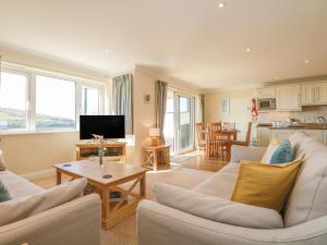 a living room with two couches and a table at 2 Burgh Island Causeway in Bigbury on Sea