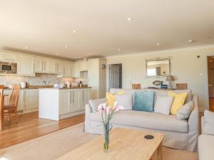 a living room with a couch and a kitchen at 2 Burgh Island Causeway in Bigbury on Sea