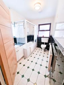 a bathroom with a toilet and a sink at 3 Bed Renovated Cottage Carramore Lake, Belmullet in Ballina