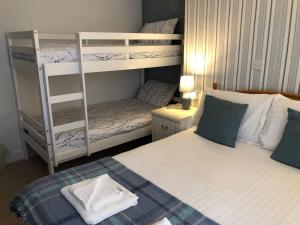 a small bedroom with two bunk beds and a bed at Bella Vista Hotel in Weston-super-Mare