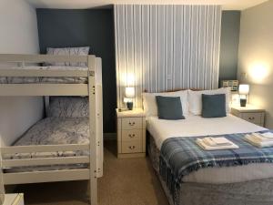 a bedroom with two bunk beds with towels on them at Bella Vista Hotel in Weston-super-Mare