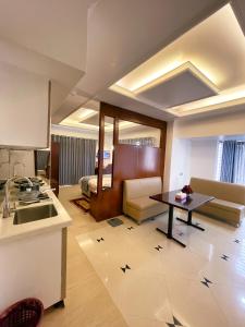 a kitchen and a living room with a table at Nascent Gardenia Residence in Dhaka