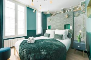 a bedroom with a large bed and blue walls at The Charming Trocadero Eiffel Tower in Paris