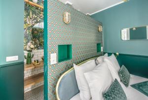 a bedroom with a bed with a blue wall at The Charming Trocadero Eiffel Tower in Paris