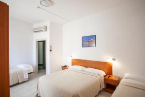 Postel nebo postele na pokoji v ubytování Hotel Viola