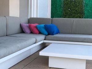 a couch with three pillows on top of it at Ático de lujo con vistas al mar in Sant Carles de la Ràpita +12 photos