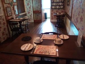 a table with plates and utensils on top of it at Weybourne Guest House in Tenby +27 photos