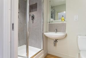 a bathroom with a shower and a sink at Claytons Cottage in Adlestrop +23 photos