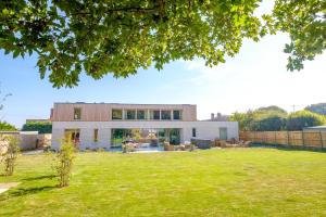 a house with a large lawn in front of it at Heath House in Thorpeness