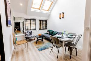 a living room with a table and a couch at Modern 2 Bedroom Queen Street Apartment in Norwich