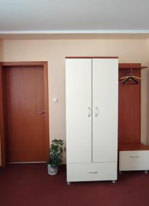 a large white cabinet in a room with a door at Hotel 21 in Bratislava