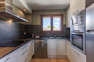 a kitchen with a sink and a window at Mas d'Aravó in Bolvir