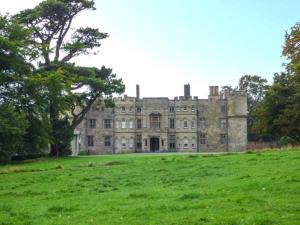 an old castle in a field of green grass at The Smithy in Leominster