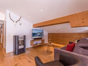 a living room with a couch and a fireplace at Wegrainhof in Kirchberg in Tirol