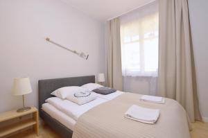 Posteľ alebo postele v izbe v ubytovaní Victus Apartamenty, Apartament Family&Friends
