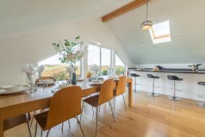 a dining room with a table and chairs at Heatherbank in St. Agnes