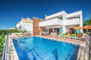 a villa with a swimming pool in front of a house at Villa Oceano in Patroves