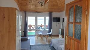 a bedroom with a bed and a table with a view at O.W. MEGA nad jeziorem in Żywiec