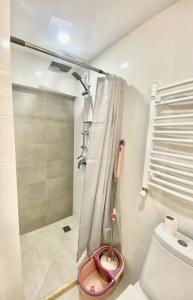 a bathroom with a toilet and a shower at GSS - A Apartment in Tbilisi City
