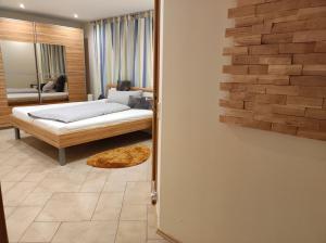 a bedroom with a bed and a mirror at Ferienwohnung Bleifuss in Altenbuch im Spessart