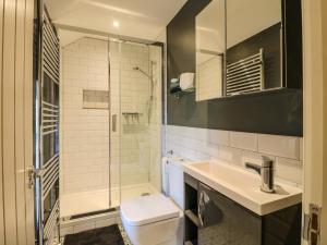 a bathroom with a shower and a toilet and a sink at Dale End Farm Cottage in Bakewell +20 photos