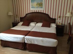 Postel nebo postele na pokoji v ubytování Hotel Cordón