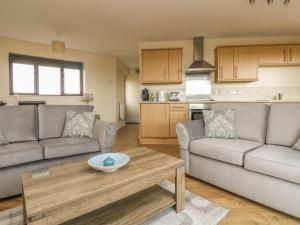 a living room with two couches and a table at Sea Horses in Marazion