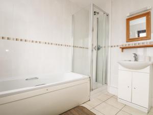 a bathroom with a white tub and a sink at Sea Horses in Marazion +16 photos