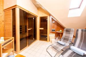 a room with two chairs and a walk in closet at Gastland M1 Hotel & Conference Center in Páty