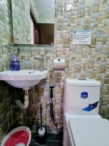 een badkamer met een toilet en een wastafel bij Cabuhat Duco Lodge 1 in Naic