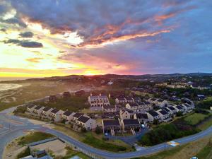 an aerial view of a town with a sunset at Settler Sands - Holsboer Vacations in Port Alfred
