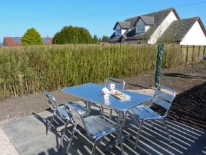 a blue table and chairs on a patio at Sky Blue Cottage in Forth