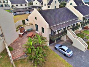 an aerial view of a house with a car parked in the driveway at Settler Sands - Holsboer Vacations in Port Alfred +14 photos