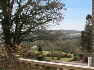 a wooden fence with a view of a garden at The Generals Cottage in Mitchel Troy