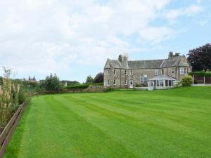 a large house with a large grass field at Priory View in Bardsea