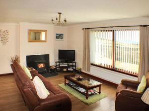 a living room with a couch and a table at Ardmore in Trumpan