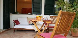 a table with a bowl of fruit on a patio at Le Caracol - Appartamenti immersi nel verde della campagna e a 1 chilometro da Orosei in Orosei