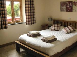 a bedroom with a bed with two pillows on it at Tyn Y Celyn Canol in Clocaenog