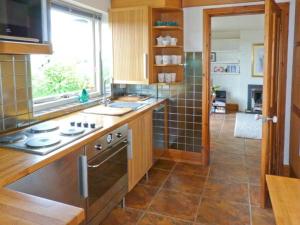 a kitchen with a counter and a stove in it at Walker's Retreat in Ambleside