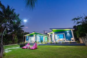 a house with pink decorations in front of it at Coco Sea Bangpo Resort in Ban Bang Po