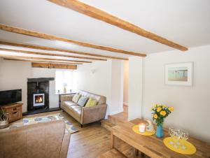 a living room with a couch and a fireplace at Bryn Coed in Porthmadog