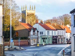 a small town with a clock tower on a street at Elizabeth House in Hornsea