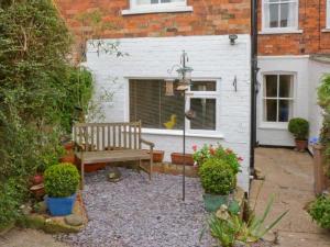 a bench in a garden in front of a house at Elizabeth House in Hornsea